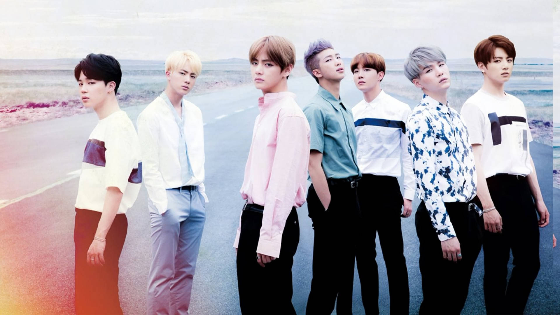 BTS erkek grubu üyeleri yoldayken havalı kıyafetler giyiyor.