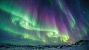Karlı bir manzara üzerinde yeşil ve mor dalgalarla canlı bir aurora borealis. — Gökyüzü manzarası Duvar Kağıdı